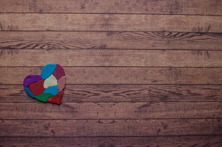 Autism awareness concept with colorful heart made of pieces of modeling clay.の写真素材
