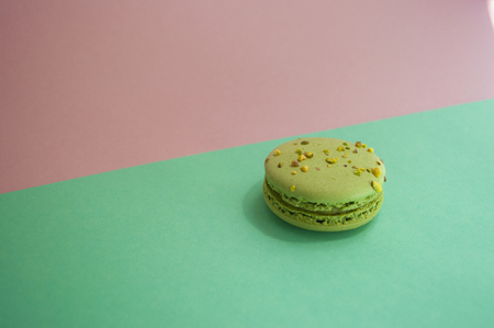 Green color macaron on purple background.の写真素材