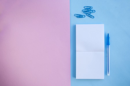 Back to school concept. School supplies on pink and blue background with text space.の写真素材