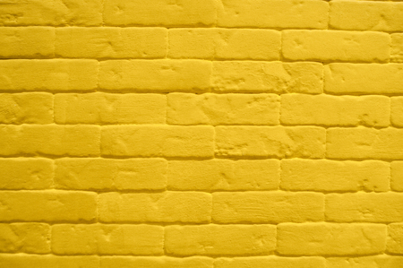 Close up of modern yellow brick tiles wall texture background.の写真素材