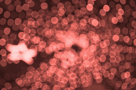 Abstract blurred living coral color background with little lights. Party concept.