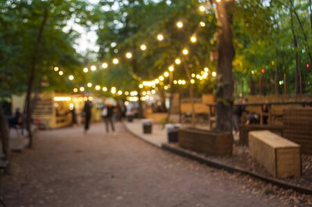 Beautiful bokeh background of the festival in the green city park.の写真素材