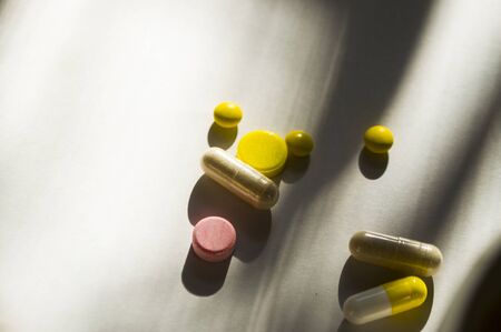 Different pills and capsules on white background with copyspace. Coronavirus outbreake concept.の写真素材