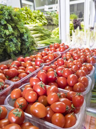 Fresh organic cherry tomatoes and greenery on the farmer market.の写真素材