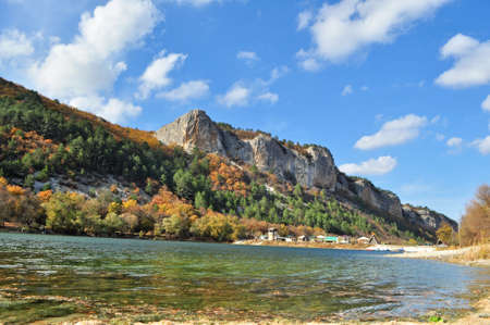 Breathtaking view of rocks covered with bright colourful autumn forest.