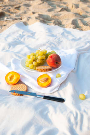 Summer picnic on the beach by the sea at a sunrise.の写真素材