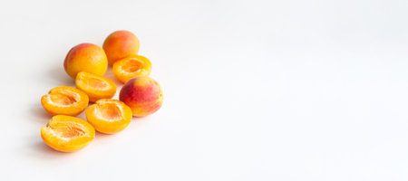 A ripe cut apricots with a seed on white background with copyspace.の写真素材