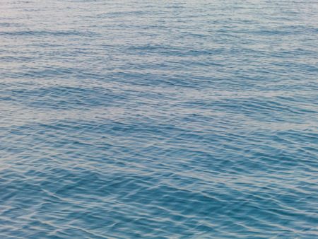 Blue sea surface with waves background