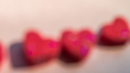 Abstract blurry background with blurry red hearts shapeの写真素材