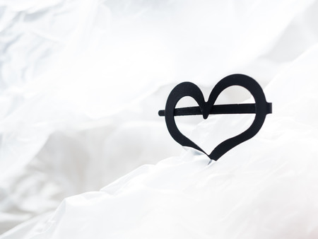 Closeup of metal black heart shape with white blurry background.
Concept and idea for loving, sharing and giving.の写真素材