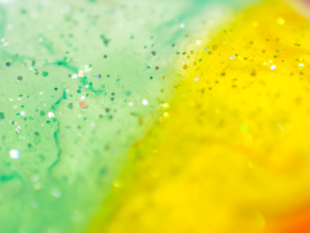 Abstract green, yellow and glitter plastic textureの写真素材