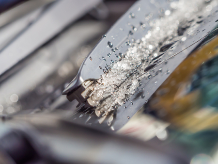 Closeup of snow melting on car 's wiperの写真素材