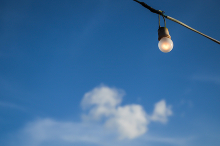 Abstract blurry light bulb and blue sky background.For power, love or ideas concepts.の写真素材