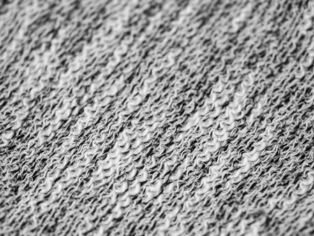 Abstract black and white tone spirals or curls pattern fabrics texture.