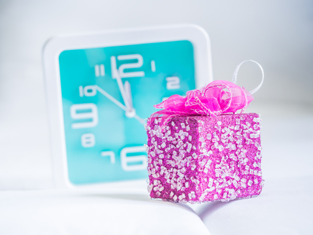 Clock and gift on fabrics background. Concepts and ideas for countdown time.の写真素材