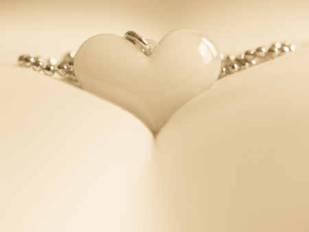 Vintage tone. Closeup of heart shape on blurry fabric texture. Concepts and ideas for love.の写真素材