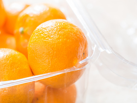 Closeup of oranges in plastic box or container.の写真素材