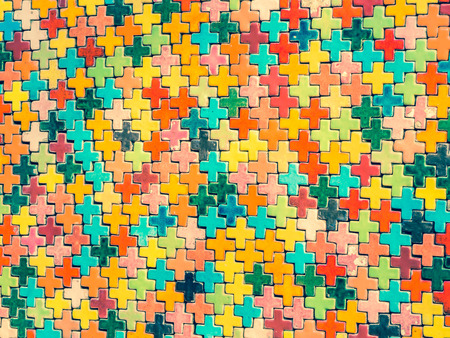 Cross processed, vintage tone. Multicolored ceramic plus symbol shapes pattern, texture and background.の写真素材