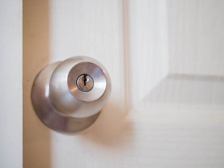 Closeup of the round door lock with wooden door.の写真素材