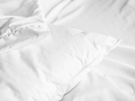 Black and white tone. Pillow and zipper cover on the bed in the bedroom.の写真素材