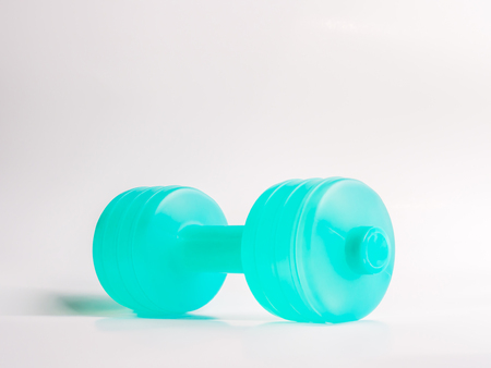 Turquoise dumbbell and gray backgroundの写真素材