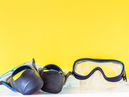 Mask and blue fins with yellow backgroundの写真素材