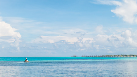 Young fishermen with clear blue sea and skyの写真素材