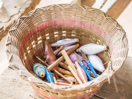 Wooden weave basket with multiple color of cotton threads for weaving fabrics prodcution.の写真素材