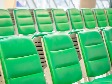 Green airport waiting chairs or seating within the terminal.の写真素材