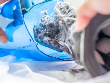 Closup of dust in the plastic box of portable or handheld vacuum cleaner.の写真素材