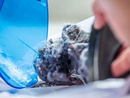 Closeup of dust in the plastic box of portable or handheld vacuum cleaner.の写真素材
