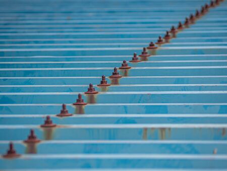 Abstract background. Diagonal striped pattern of brown rusty knots and horizontal lines blue metal...