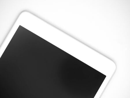 Top view or directly above and closeup of white tablet with black screen display on gray background.