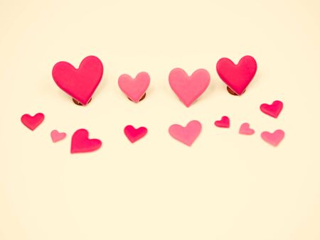 Crossed process tone of sweet and romance red and pink hearts shape on yellow pastel color background. Valentine 's day, wedding or love concepts and ideas.の写真素材