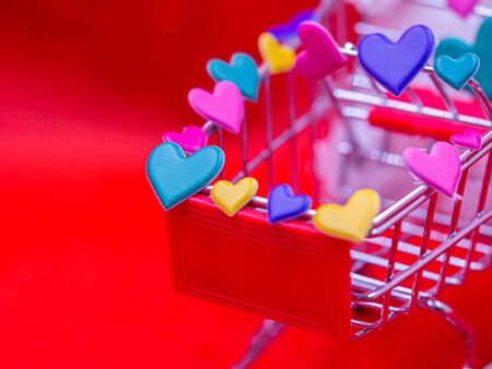 Closeup of green heart sticker on 
 supermarket cart with blurry vivid, vibrant red background for Love, romance, shopping, business, greeting card concept and idea.の写真素材