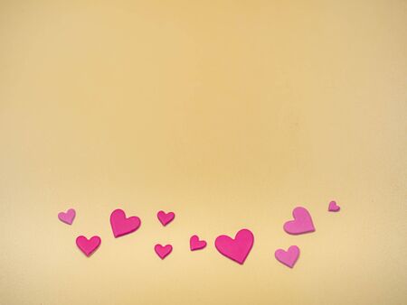 Pink heart shape paper stickers on golden color background for valentines day, love, wedding concept...
