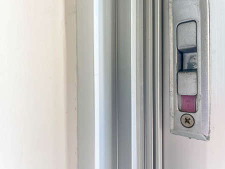 Abstract background and texture of cement or concrete wall, aluminuim door flame and locked latch.の写真素材