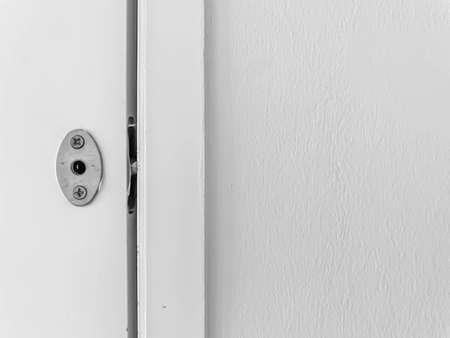 Abstract background and texture. Black and white tone of cement or concrete wall, wooden window flame and latch.の写真素材