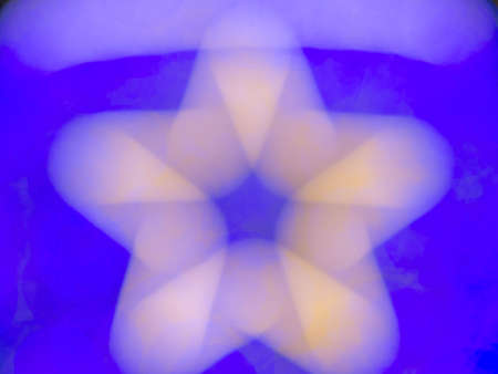 Abstract blurry yellow or golden color  star shape on vivid blue bokeh, glitter for pattern, texture and backgroundの写真素材