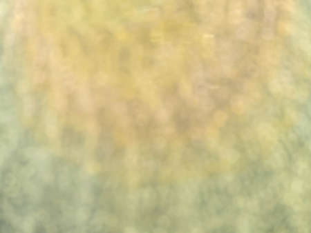 Abstract blurry yellow pastel color bokeh glitter pattern,  texture and background for night light, party, festival, celebration or summer season concepts and ideaの写真素材