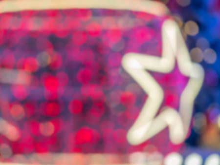 Abstract blurry red and pink bokeh, glitter and white star shape for pattern, texture and backgroundの写真素材