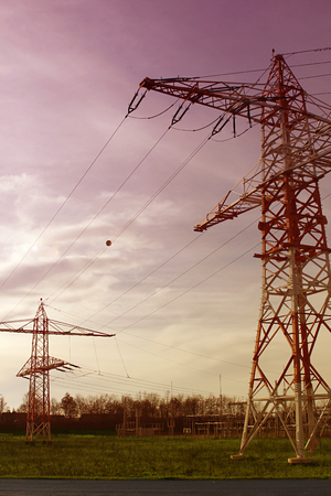 tower for electricity in rural landscape in the sunsetの写真素材