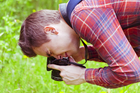 A young man takes photos of nature. Summer-Autumn.