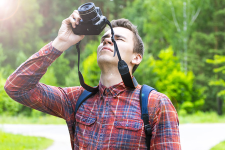 A young man takes photos of nature. Summer-Autumn.