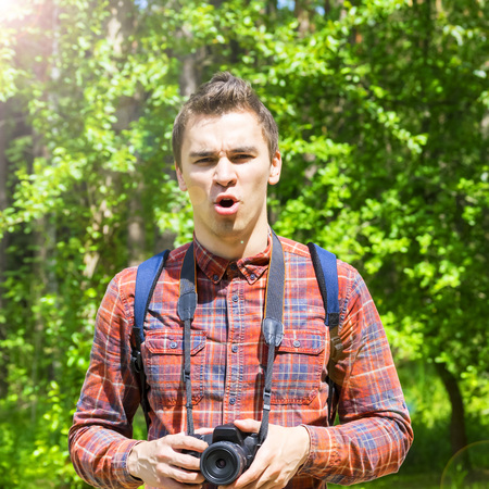 A young man takes photos of nature. Summer-Autumn.の写真素材