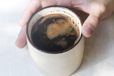 Young man drinks coffee morning, summer, autumn.の写真素材