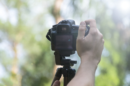 The man sets the camera on a tripodの写真素材