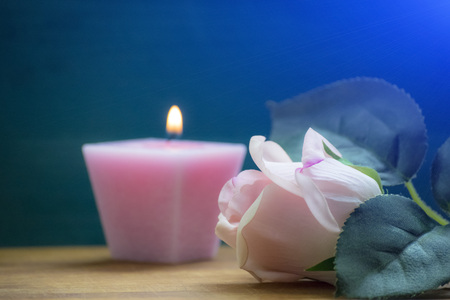 Rose and candle on the tableの写真素材