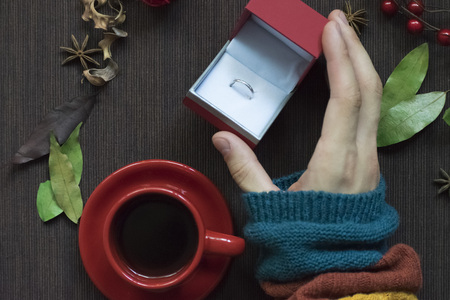 A man holding an engagement ring. Offer hand and heart Christmas