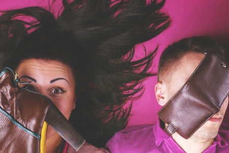 Girl happy shopping, man with empty walletの写真素材